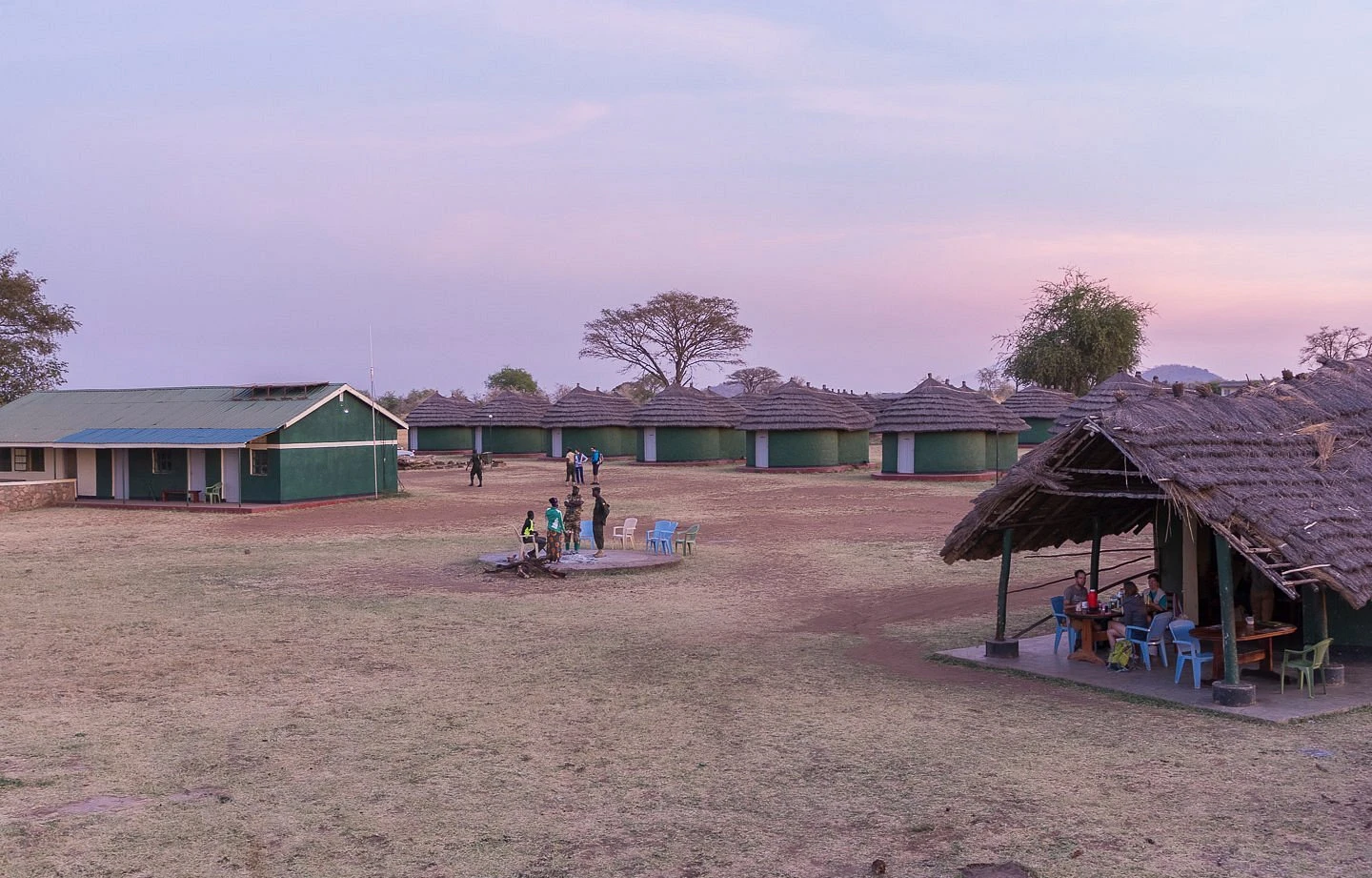 Apoka Rest Camp chalets with savannah backdrop