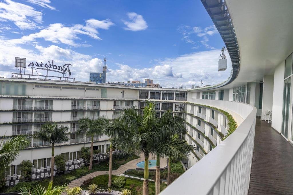 Radisson Blu Kigali hotel exterior showcasing modern design and greenery