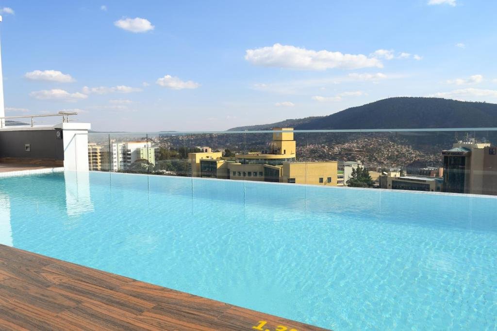 Swimming pool area at Ubumwe Grande Hotel with comfortable lounge chairs