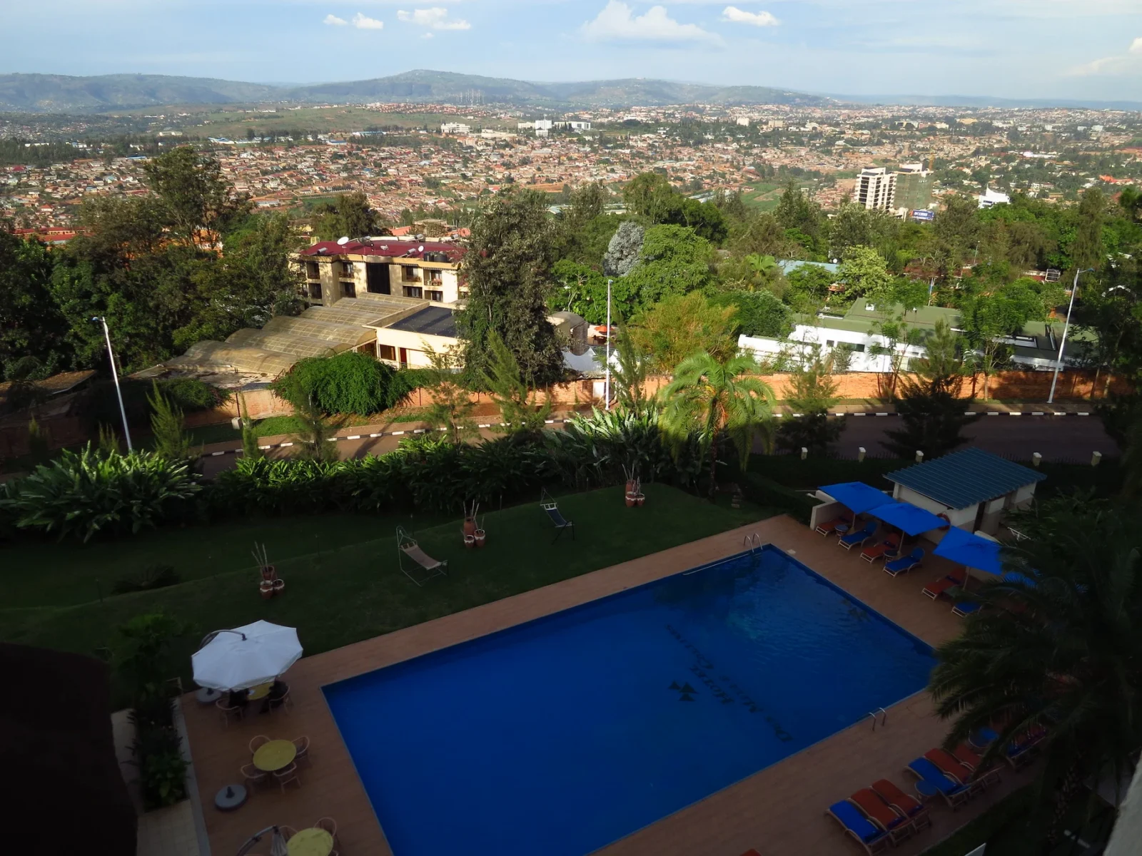 Hotel des Mille Collines pool area with clear water and loungers